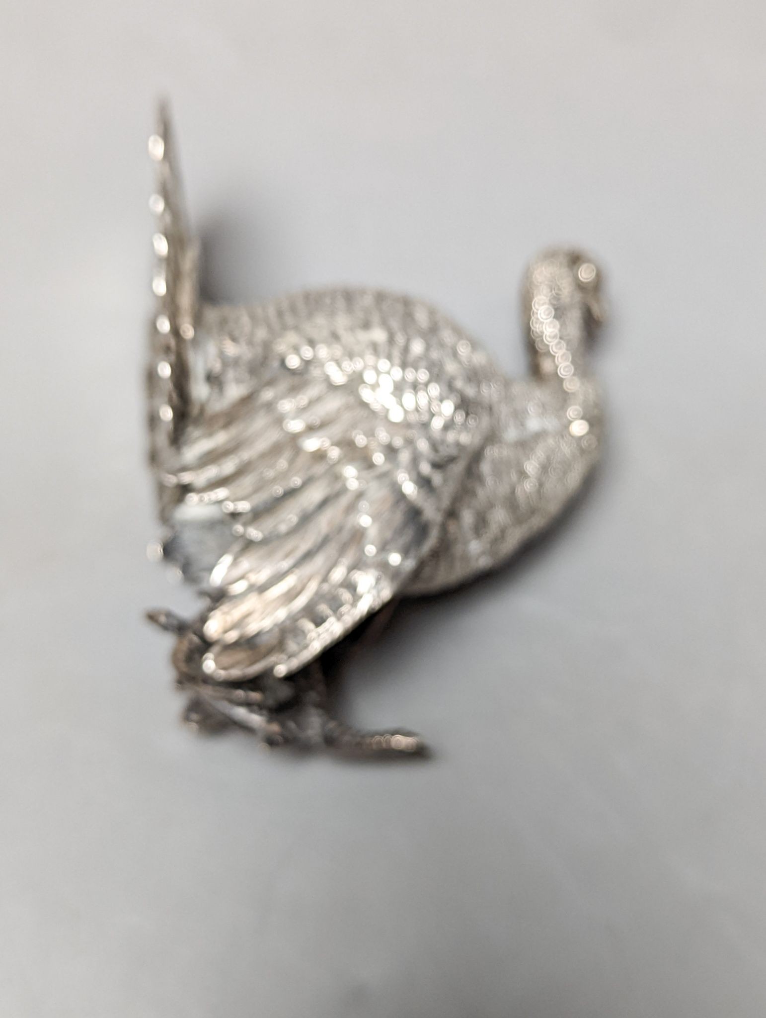 A late 19th /early 20th century Hanau silver free standing model of a game bird, 1930's import marks, height 10.4cm, 180 grams.